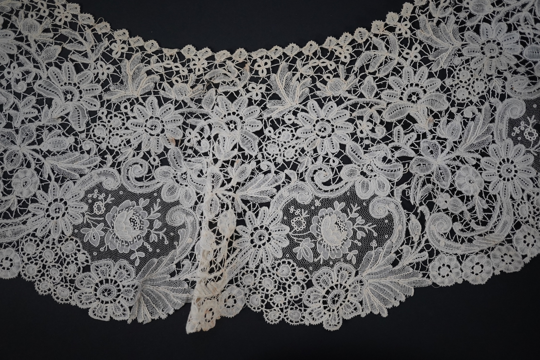 An 1860’s unused, large circular flounce shaped collar of mixed Brussels bobbin lace, with twelve needle lace Point de Gaz insertions, 18.5cm deep, approximately 248cm along bottom, edge. Condition - good